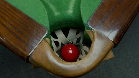 Balls Falling Into Pockets On A Billiard Table