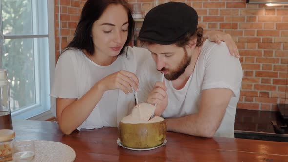 Close Up of Young Couple Enjoying Their Time Drinking a Fresh Coconut