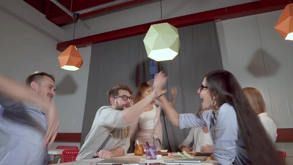 Business Team of Young People Are Folding Hands Together and Screaming in Office