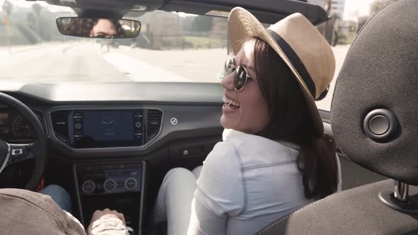 Happy Young Couple Laughing on Cabriolet Road Trip