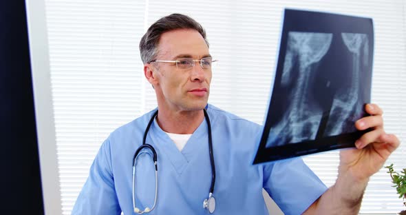 Male doctor examining an x-ray