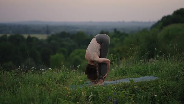 Young Woman Practicing Yoga in the Nature