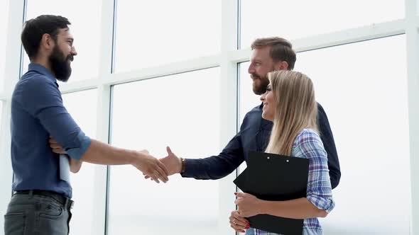 Employees Meeting a Client in the Office Lobby