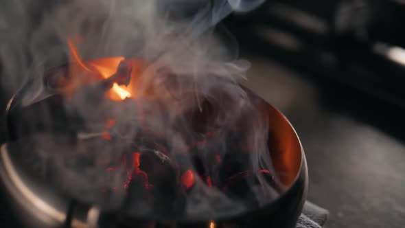 Red Chili Peppers and Herbs Spices with Fire on Modern Kitchen in Restaurant