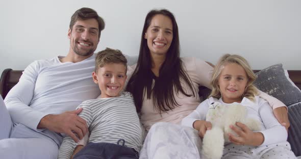 Family sitting together in bedroom at home 4k