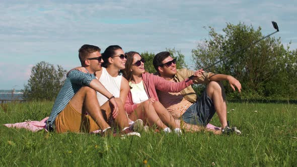 Friends Taking Picture By Selfie Stick in Summer 