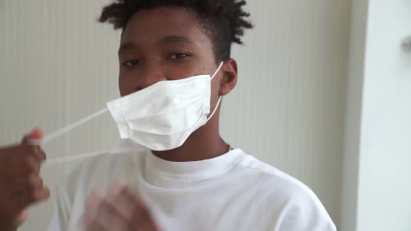 Young African Man Take Off Face Mask Removing From Face