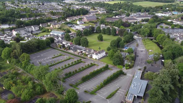 Blarney village and large castle car park Ireland drone aerial footage