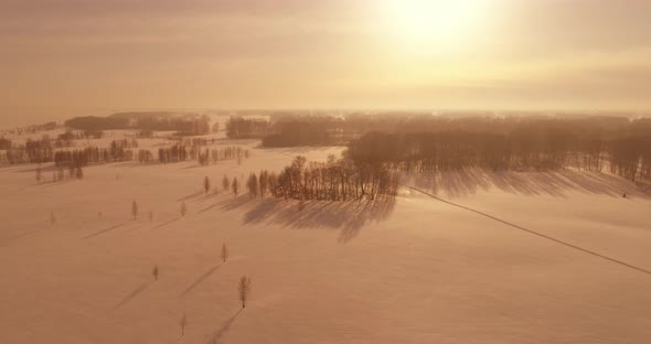 Aerial View of Cold Winter Landscape Arctic Field Trees Covered with Frost Snow Ice River and Sun