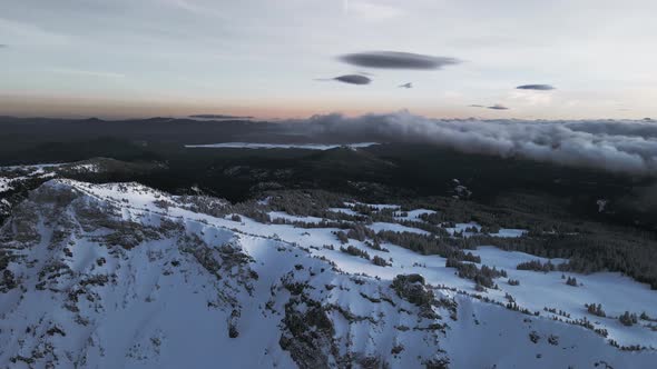 Drone shot of mountain valley covered with evergreen forest, Crater Lake, Oregon