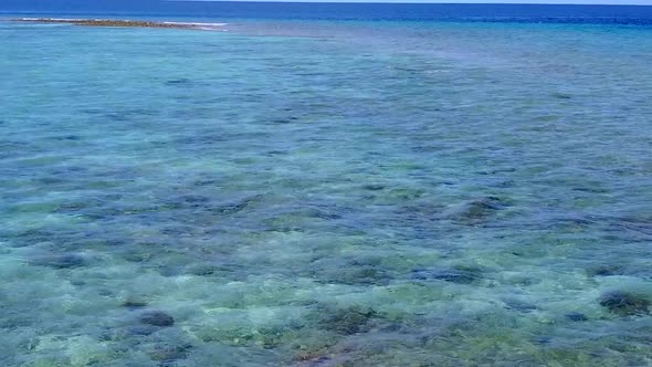 Daytime landscape of tropical coastline beach by clear water with sand background after sunrise