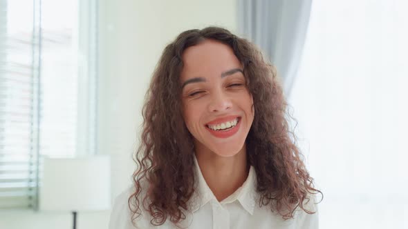 Portrait of Latino Beautiful girl in pajamas smile and look at camera.