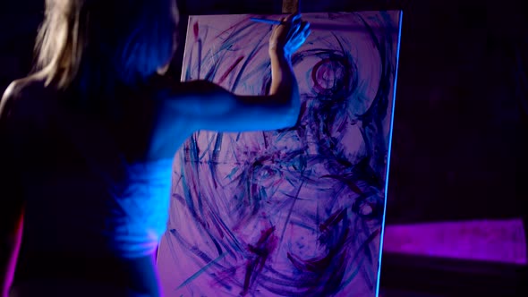 Adult Woman is Drawing Emotionally on White Sheet in Dark Artistic Studio Inspired By Her Nightmare