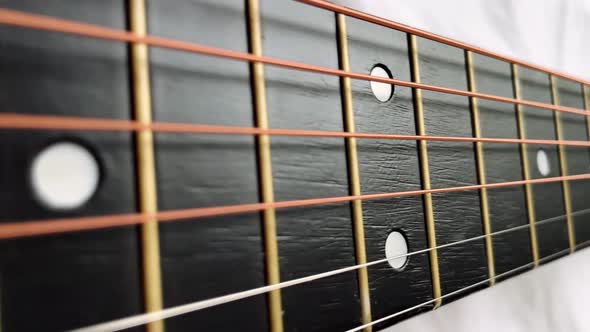 Zoom in Shot of Black Frets Fretboard Acoustic Guitar String