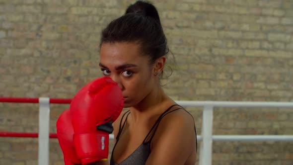 Determined Athletic African Woman Fighter in Boxing Gloves in Fighting Stance