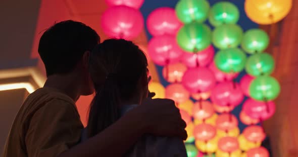 Couple look at the chinese lantern together at outdoor 