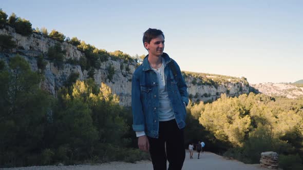 The Guy Enjoys Nature, Mountains and Azure Sea. A Young Man Explores the Rocks in the South of