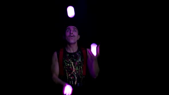 Juggler Showing Tricks with Light Balls in the Whole Dark