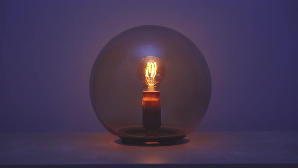Close up on a spherical lamp that then turn off
