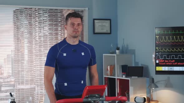 Multiracial Doctor Increasing Speed on the Treadmill During the Athlete Stress Test