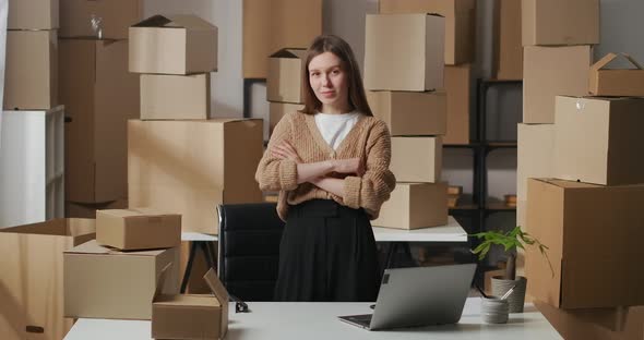 Successful Businesswoman in Room of Apartment Using As Warehouse for Boxes with Goods for Business