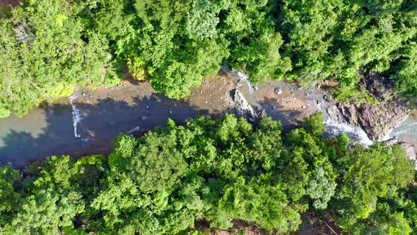 Idyllic Landscape Of Rio Higuero With Lush Vegetation In Summer - aerial top down