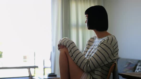 Woman relaxing in living room at home 