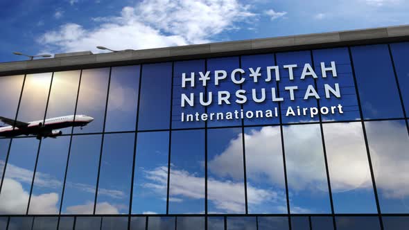 Airplane landing at Nur-Sultan, Astana Kazakhstan airport mirrored in terminal