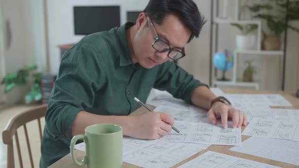 Asian Man Drawing Storyboard Animation Comic Cartoon, Design Creative Scene Layout At Studio