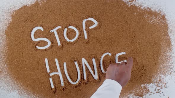 Hand Writes On Soil  Stop Hunger