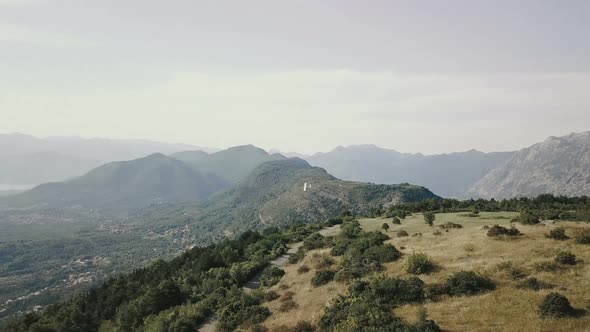 Aerial view of toy airplane flies over the mountains in Montenegro