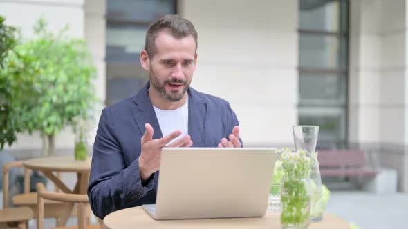 Man Celebrating While Using Laptop Outdoor