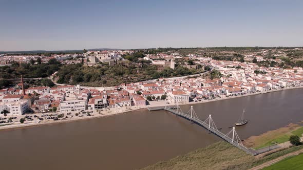 Cityscape of Alcaçer Do Sal city in Portugal with bridge, aerial drone view