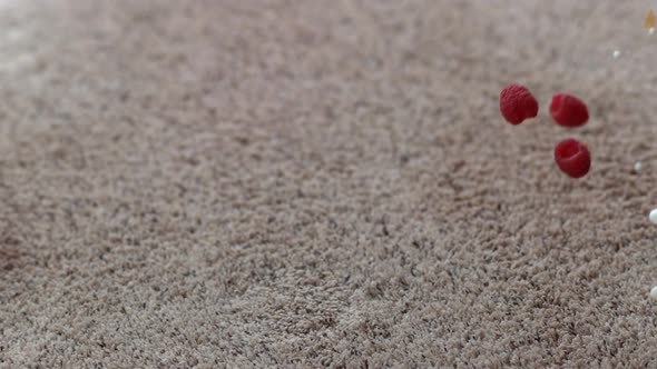 Bowl of cereal and raspberries spilling on carpet in slow motion; shot on Phantom Flex 4K at 1000 fp