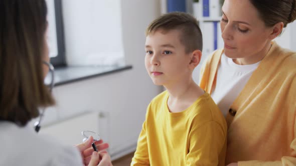 Mother Son and Doctor with Stethoscope at Clinic