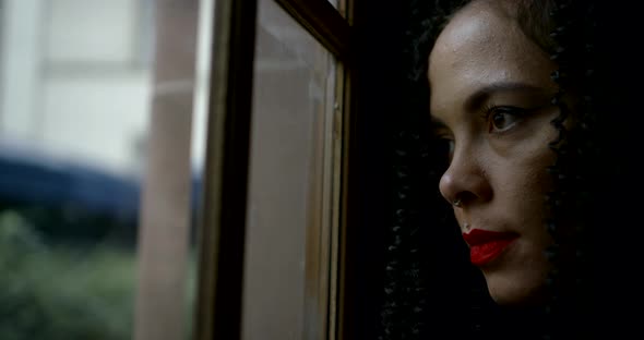 Close-up Portrait of a Bright, Burning Brunette with Curly Hair, Her Face Red Lipstick, Bright