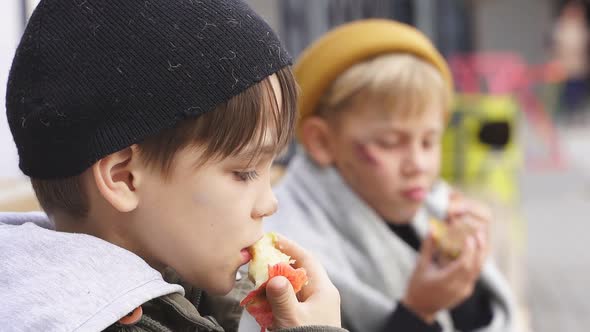 Poor Street Kids Enjoy Meal on Street Eating Donationa Food Sitting Together in Dirty Clothes