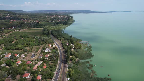 Aerial view of Lake Balaton, road, houses, fields and gardens in Hungary