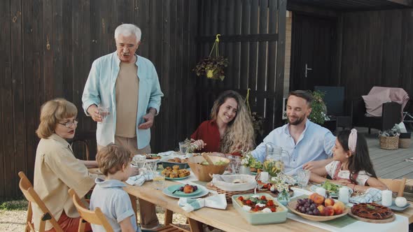 Family Celebrating at Table Outdoors