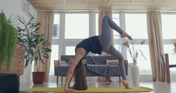 Healthy and Pretty Woman Exercising at Home Practicing Stretching in Living Room Enjoying Morning