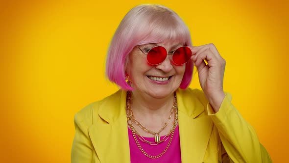 Happy Playful Elderly Granny Woman in Red Sunglasses Blinking Eye Looking at Camera with Smile