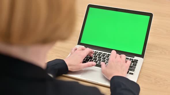 Old Businesswoman Using Laptop with Chroma Screen