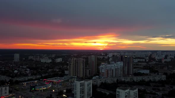 Epic aerial fly around, sunset in city district