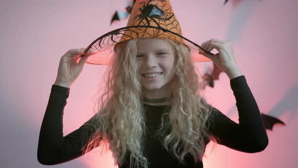 Halloween Kids Portrait Blonde Girl in Witch Costume at Home