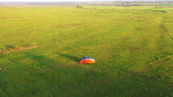 Motor Paraglider Starts To Take Off on the Field, but the Pilot Makes a Mistake When Taking Off and