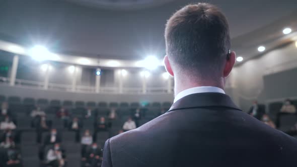 a Man Speaking to an Audience at a Conference