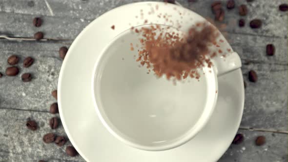 Super Slow Motion Instant Coffee Falls Into a Cup of Water