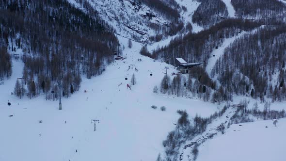 Flying up to ski lifts at busy resort in winter