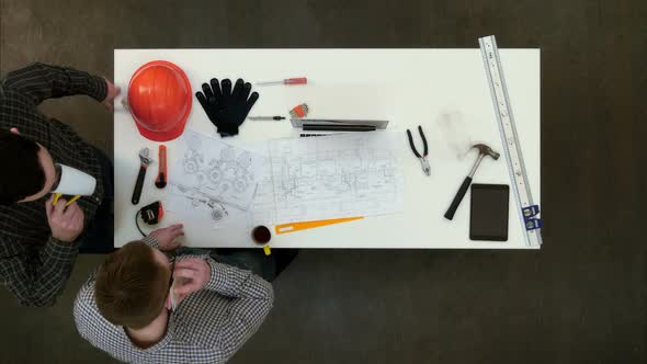 Two Architects Having Phone Call During Coffee Break