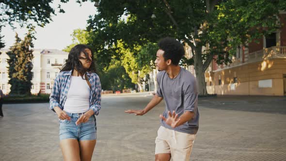 Darkskinned Friends are Smiling and Dancing at City Square